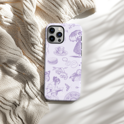 Phone case with purple illustrations on a textured beige surface