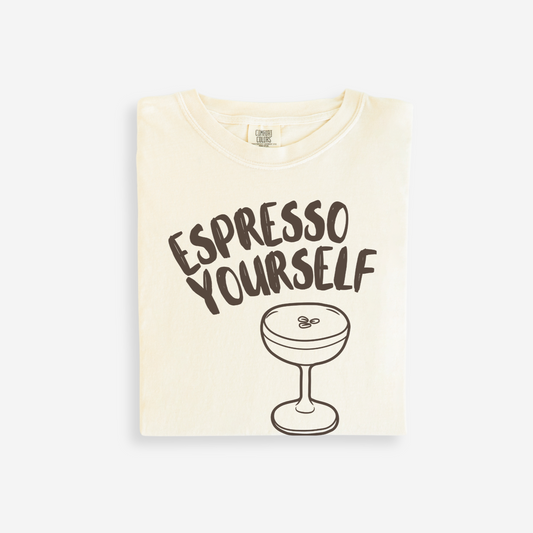 Beige t-shirt with 'Espresso Yourself' text and espresso cup graphic on a white background
